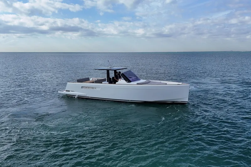 Slide: The Image of 2013 Fjord 40' Open yacht cruising on calm ocean waters under a partly cloudy sky. - 58