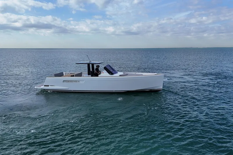Slide: The Image of 2013 Fjord 40' Open yacht cruising on calm ocean waters under a partly cloudy sky. - 59