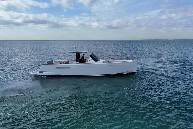Slide: The Image of 2013 Fjord 40' Open yacht cruising on calm ocean waters under a cloudy sky. - 60