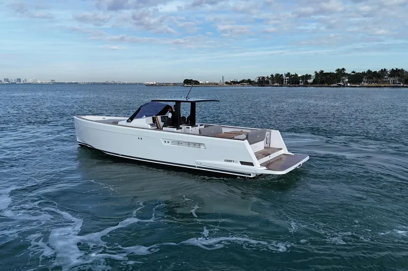 Slide: The Image of 2013 Fjord 40' Open yacht cruising on calm waters under a partly cloudy sky. - 61