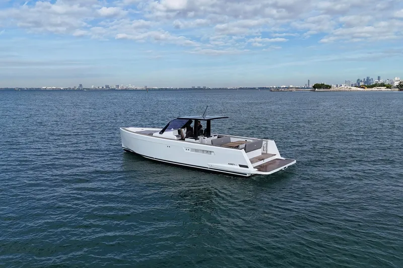 Slide: The Image of 2013 Fjord 40' Open yacht cruising on calm waters under a partly cloudy sky. - 67