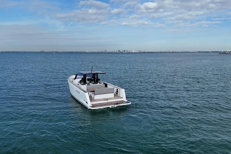Slide: The Image of 2013 Fjord 40' Open yacht cruising on calm ocean waters under a partly cloudy sky. - 68
