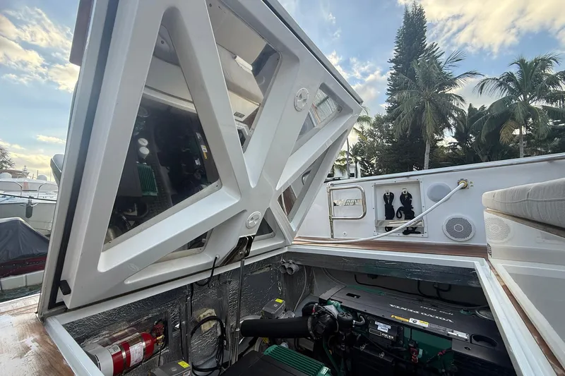 Slide: The Image of Engine compartment of a 2013 Fjord 40' Open yacht with open hatch, surrounded by palm trees. - 73