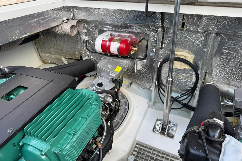 Slide: The Image of Engine compartment of a 2013 Fjord 40' Open boat, featuring a fire extinguisher and insulation. - 74