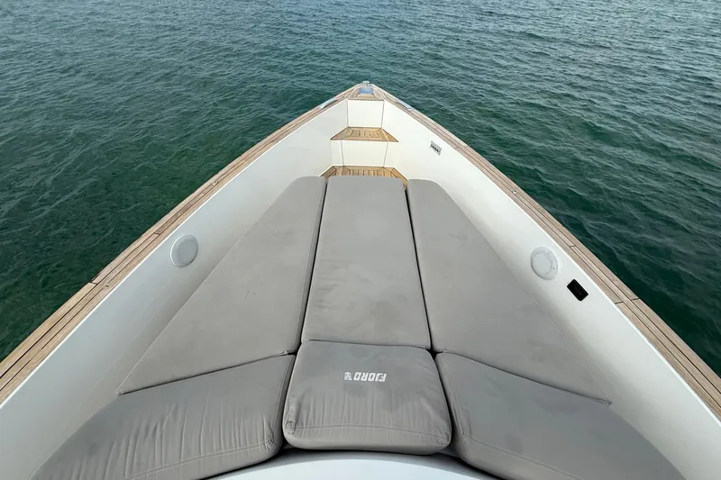 Slide: The Image of Bow view of 2013 Fjord 40' Open yacht with cushioned seating on calm water. - 79