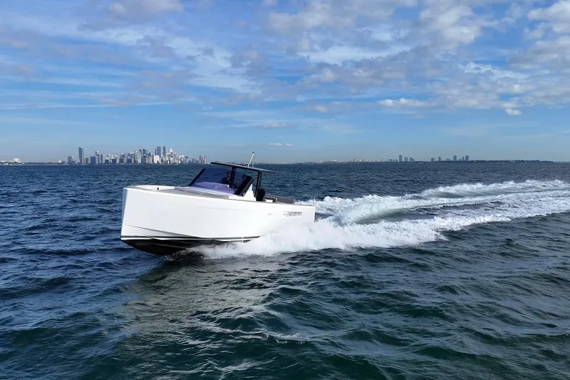 Slide: The Image of 2013 Fjord 40' Open yacht cruising on ocean with city skyline in background. - 8