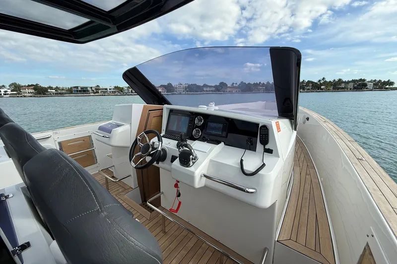 Slide: The Image of Helm of 2013 Fjord 40' Open yacht with modern controls and scenic water view. - 89