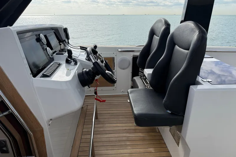 Slide: The Image of Helm of 2013 Fjord 40' Open yacht with dual seats and navigation controls. - 90