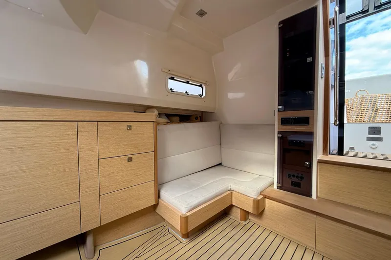 Slide: The Image of Interior of 2013 Fjord 40' Open yacht with modern wood cabinetry and seating. - 98