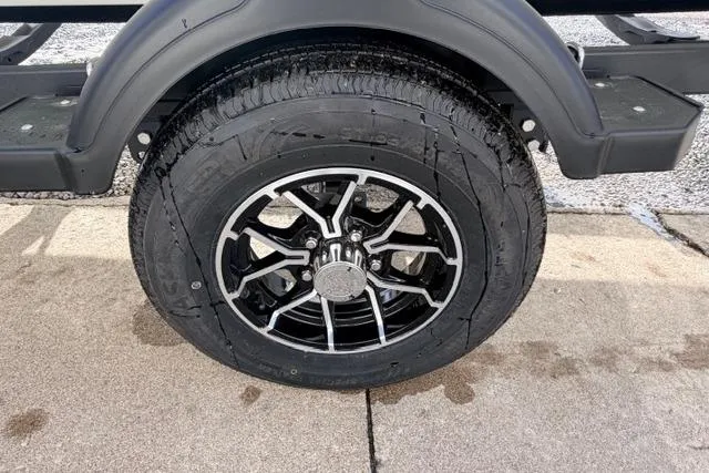 Slide: The Image of 2026 Crestliner 1700 Storm trailer wheel with sleek black and silver alloy rim. - 11