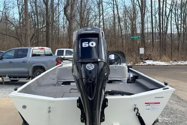 Slide: The Image of 2026 Crestliner 1700 Storm boat with Mercury 60 engine, parked outdoors. - 4