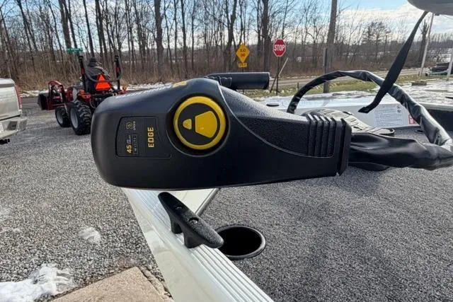 Slide: The Image of Trolling motor control on 2026 Crestliner 1700 Storm boat, outdoors with trees and stop sign. - 8