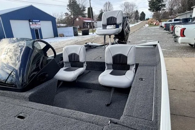 Slide: The Image of 2026 Crestliner 1700 Storm boat with dual seats and console, parked outdoors. - 9