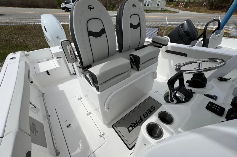 Slide: The Image of 2026 Sea Pro 262 Offshore boat interior with dual seats and steering console. - 11