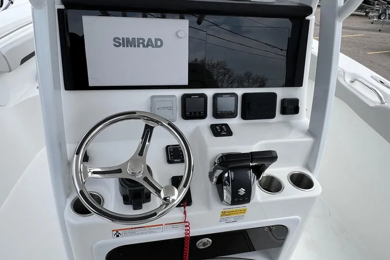 Slide: The Image of Steering console of 2026 Sea Pro 262 Offshore boat with Simrad display and controls. - 12