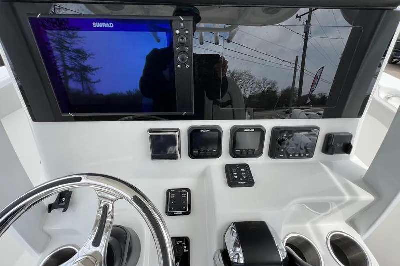 Slide: The Image of 2026 Sea Pro 262 Offshore dashboard with Simrad display and Suzuki controls. - 13