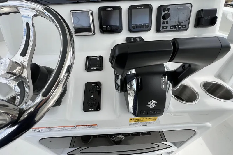 Slide: The Image of 2026 Sea Pro 262 Offshore boat dashboard with steering wheel and control panel. - 16