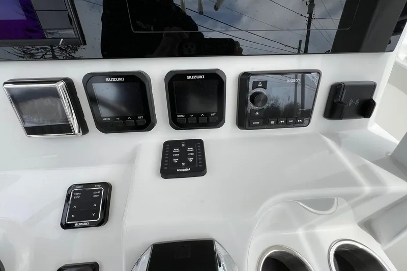 Slide: The Image of Control panel of 2026 Sea Pro 262 Offshore boat with Suzuki displays and audio system. - 17