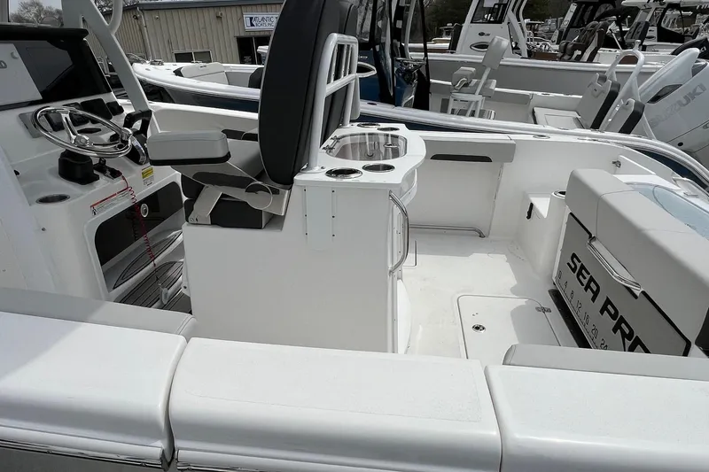 Slide: The Image of 2026 Sea Pro 262 Offshore boat interior with seating and steering console. - 19