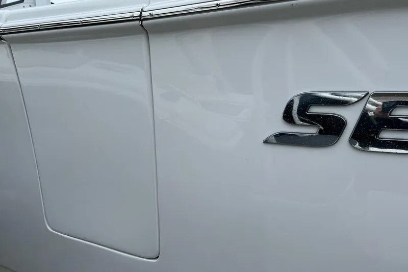 Slide: The Image of 2026 Sea Pro 262 Offshore boat side view with logo detail. - 23