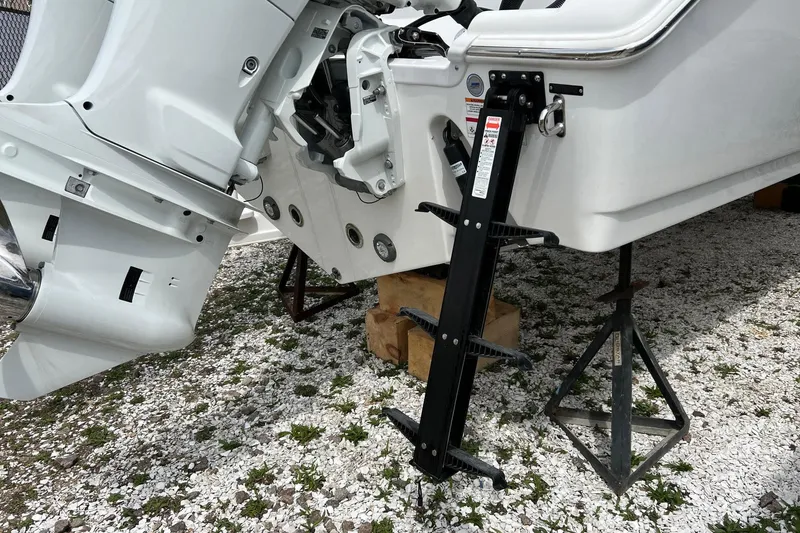 Slide: The Image of 2026 Sea Pro 262 Offshore boat with outboard motor and ladder on gravel. - 25