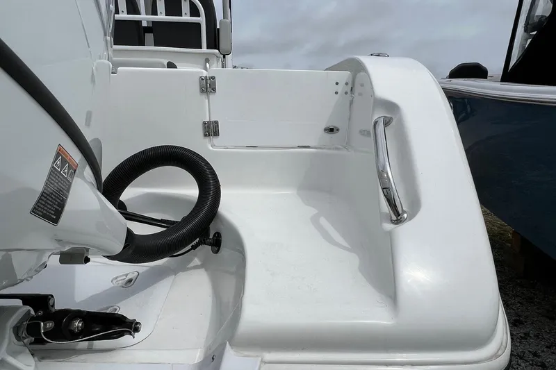 Slide: The Image of 2026 Sea Pro 262 Offshore boat stern with sleek white finish and stainless steel handle. - 26