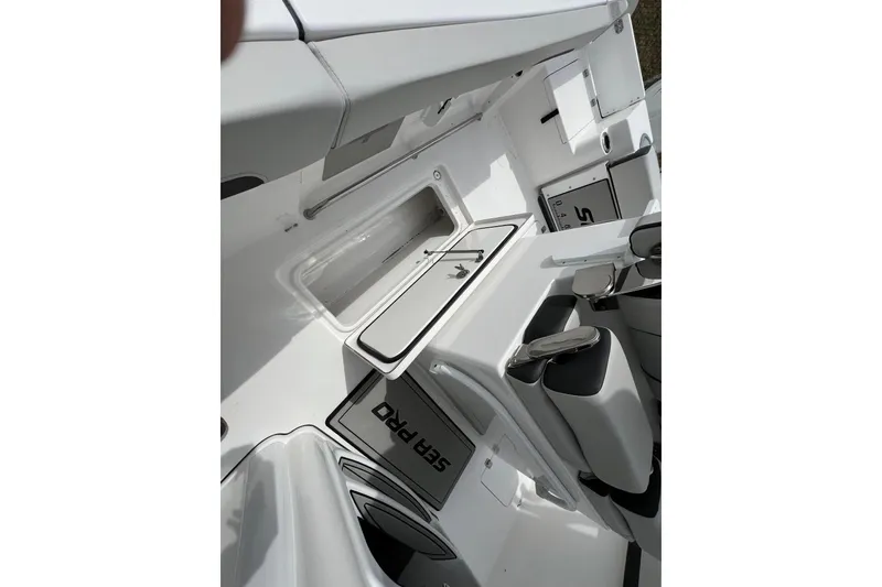 Slide: The Image of Interior view of 2026 Sea Pro 262 Offshore boat, showcasing seating and storage compartments. - 29