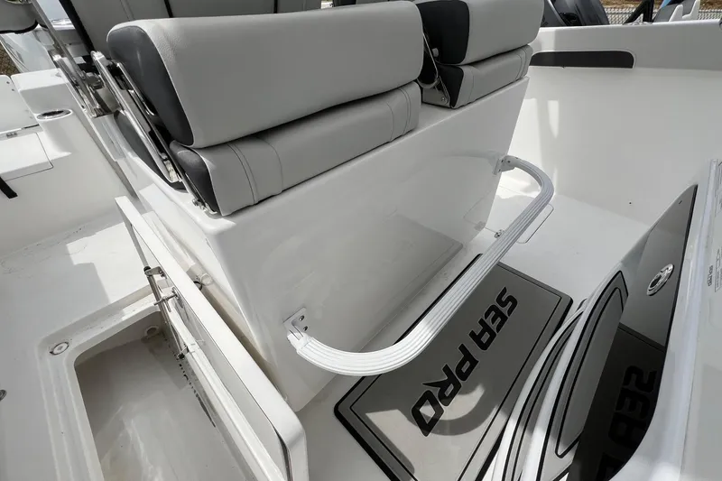 Slide: The Image of 2026 Sea Pro 262 Offshore boat interior with gray seating and branded flooring. - 30