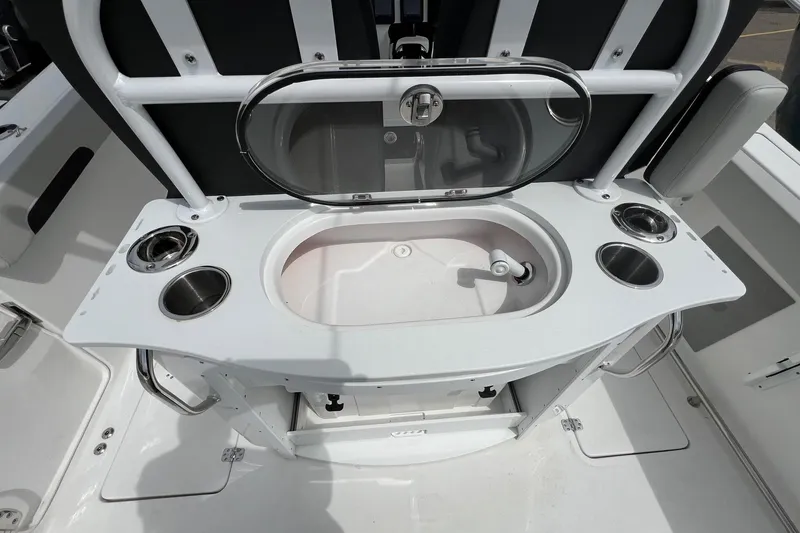 Slide: The Image of 2026 Sea Pro 262 Offshore boat interior with sink and cup holders. - 32
