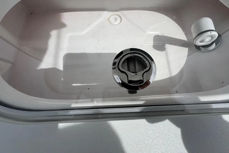 Slide: The Image of 2026 Sea Pro 262 Offshore boat livewell with chrome fittings and drain plug. - 38