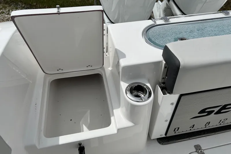 Slide: The Image of Open storage compartment on 2026 Sea Pro 262 Offshore boat with cup holder. - 39