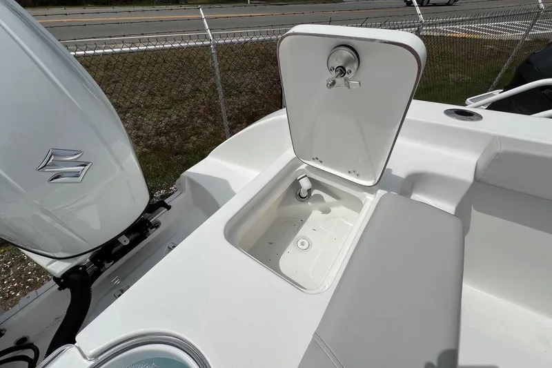Slide: The Image of 2026 Sea Pro 262 Offshore boat with open storage compartment and Suzuki outboard motor. - 42