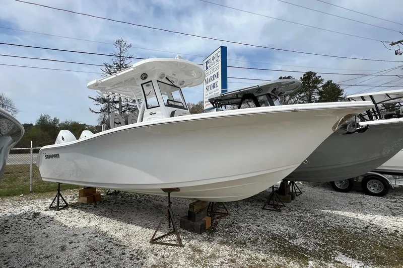 The Image of 2026 Sea Pro 262 Offshore boat displayed at a marine store, elevated on stands. - 6
