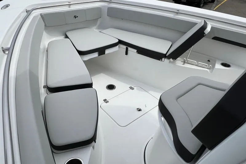 Slide: The Image of 2026 Sea Pro 262 Offshore boat interior with cushioned seating and storage compartments. - 9