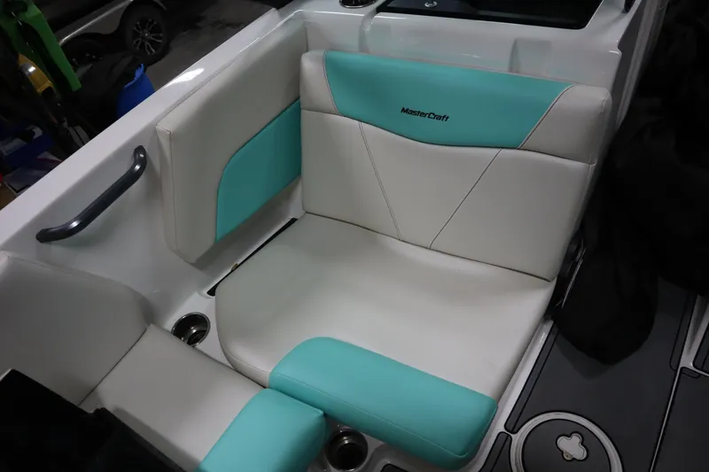 Slide: The Image of 2020 MasterCraft NXT22 boat interior with teal and white seating. - 13