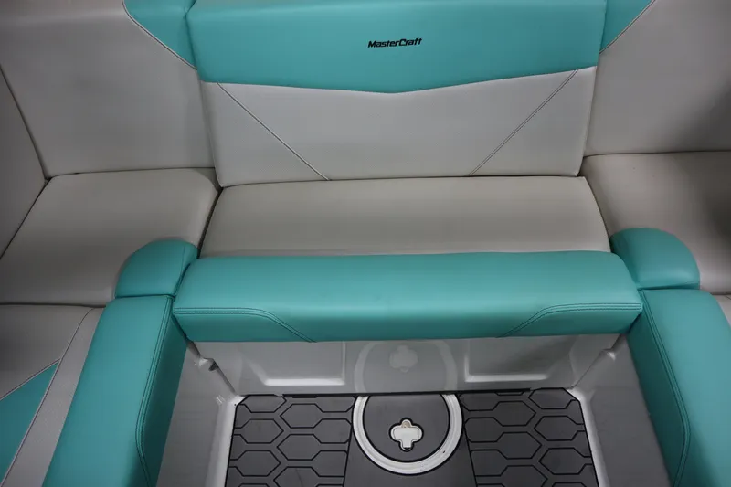 Slide: The Image of 2020 MasterCraft NXT22 boat interior with teal and white seating. - 18
