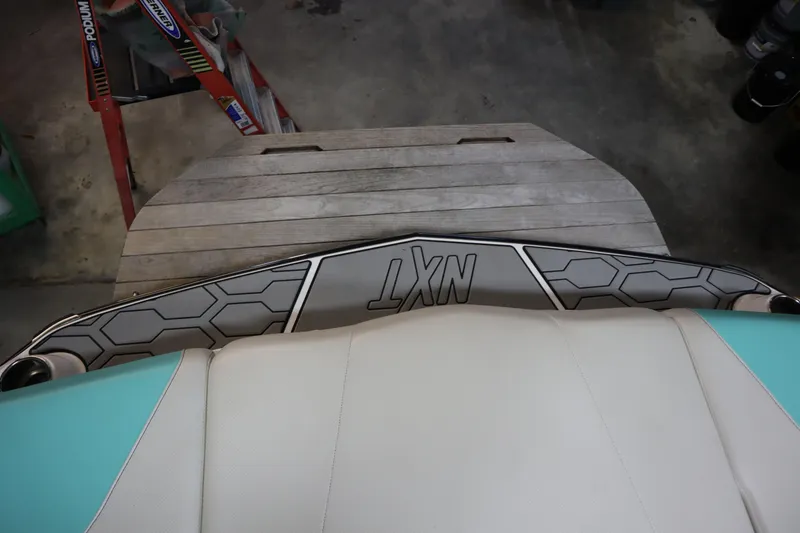 Slide: The Image of 2020 MasterCraft NXT22 boat interior with hexagonal design and teal accents. - 24