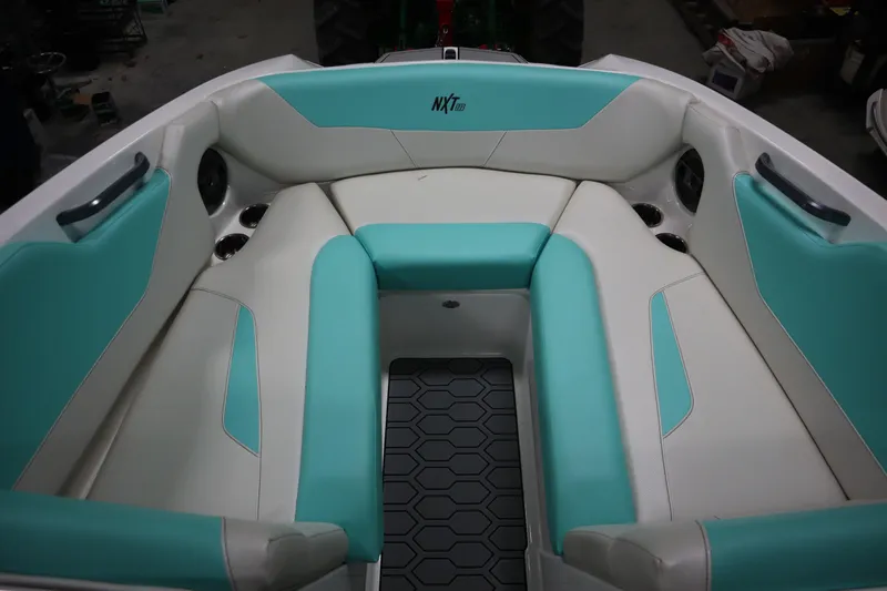 Slide: The Image of 2020 MasterCraft NXT22 boat interior with teal and white seating. - 4