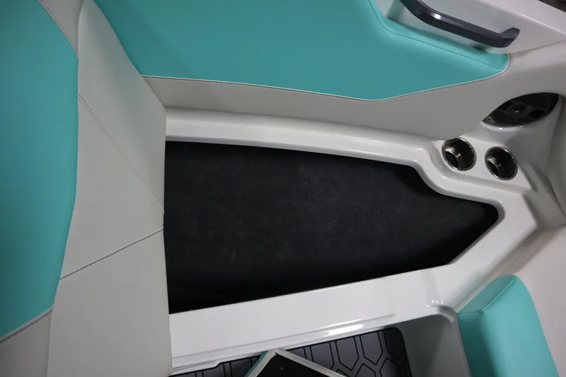 Slide: The Image of 2020 MasterCraft NXT22 interior with teal and white seating, cup holders, and sleek design. - 6
