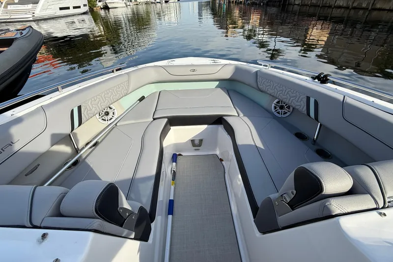 Slide: The Image of 2024 Regal LX9 boat interior with sleek seating and waterfront view. - 11