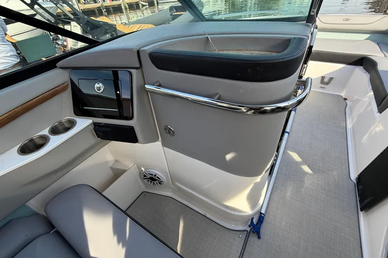 Slide: The Image of 2024 Regal LX9 boat interior with cup holders, storage, and sleek design. - 16