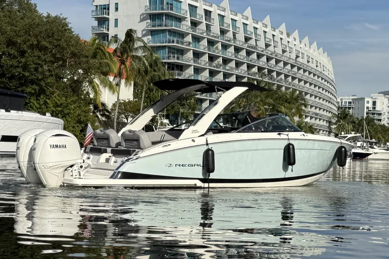 Slide: The Image of 2024 Regal LX9 boat on water, cityscape background, Yamaha engine visible. - 7