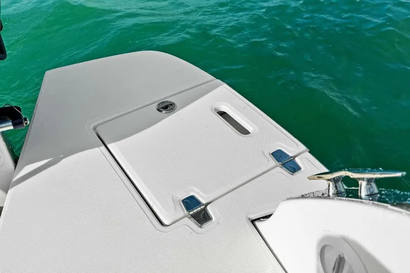 Slide: The Image of 2023 Regal 29 OBX boat deck with sleek design on turquoise water. - 12