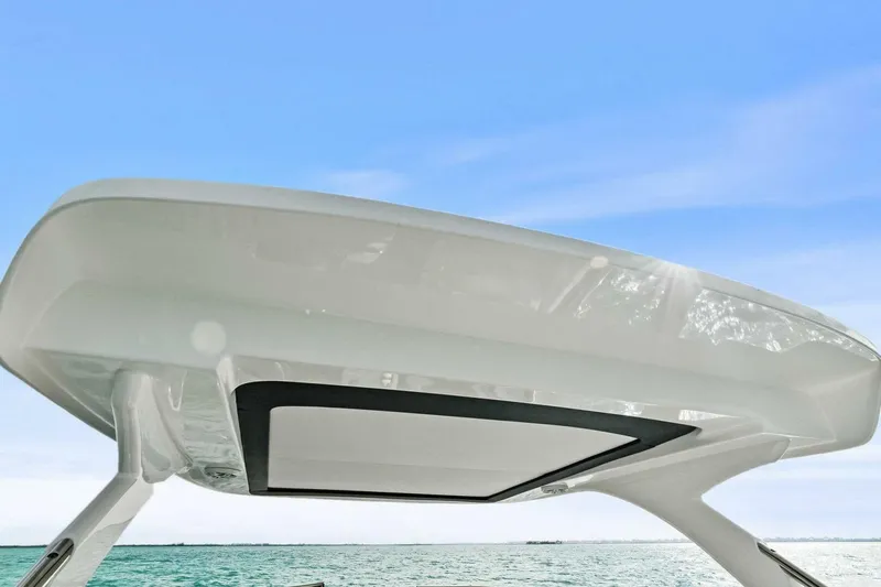 Slide: The Image of 2023 Regal 29 OBX boat canopy against clear blue sky and ocean backdrop. - 13