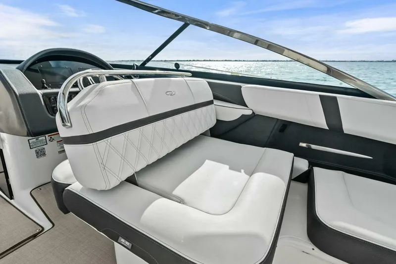 Slide: The Image of 2023 Regal 29 OBX boat interior with luxurious white seating and sleek dashboard design. - 3