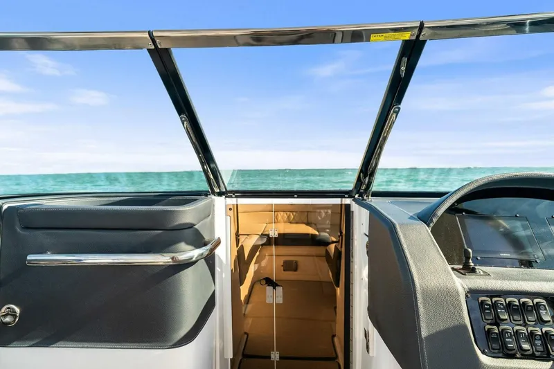 Slide: The Image of 2023 Regal 29 OBX boat interior with ocean view through windshield. - 31