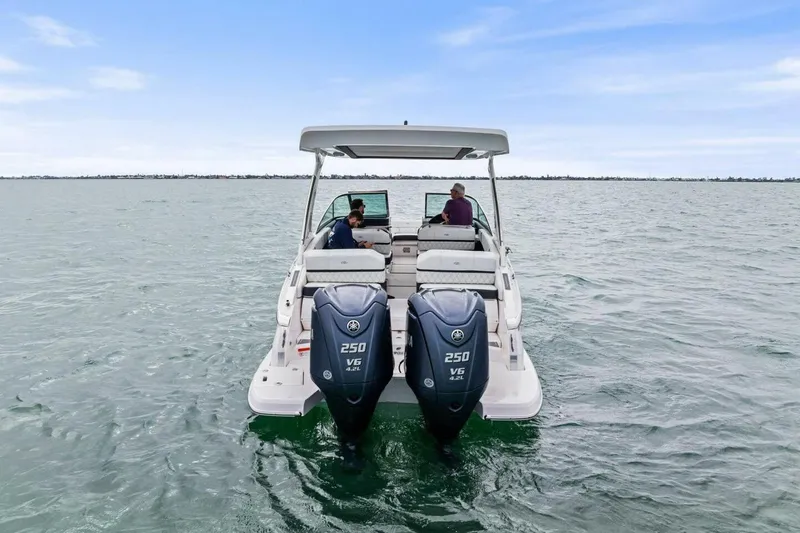 Slide: The Image of 2023 Regal 29 OBX boat with dual engines cruising on open water. - 34
