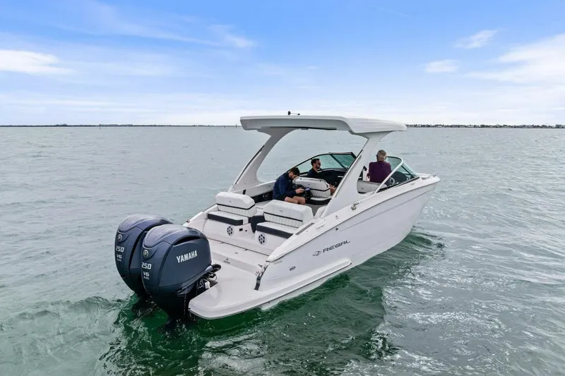 Slide: The Image of 2023 Regal 29 OBX boat with Yamaha engines cruising on open water. - 35