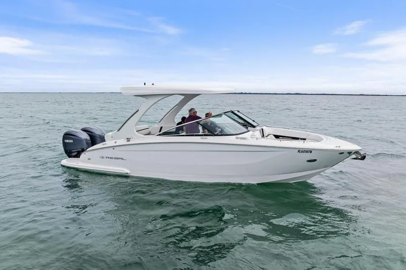 Slide: The Image of 2023 Regal 29 OBX boat cruising on open water with Yamaha engines. - 37