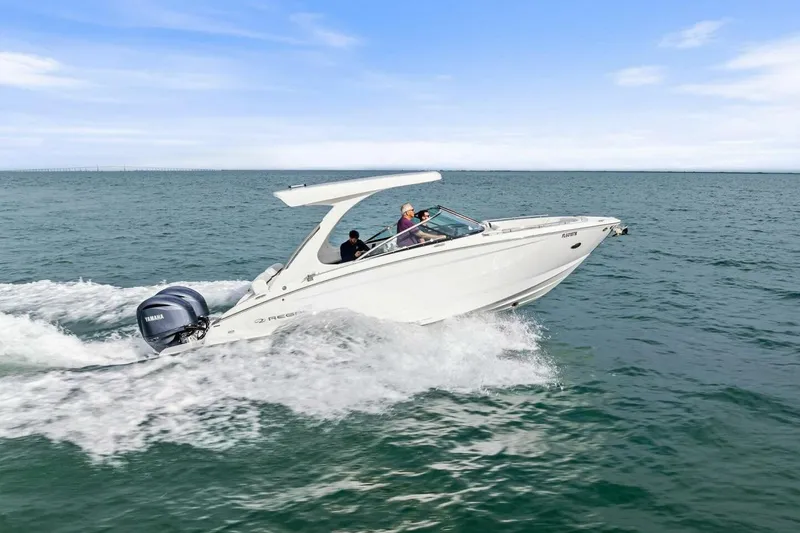 Slide: The Image of 2023 Regal 29 OBX boat cruising on open water with Yamaha engine. - 41